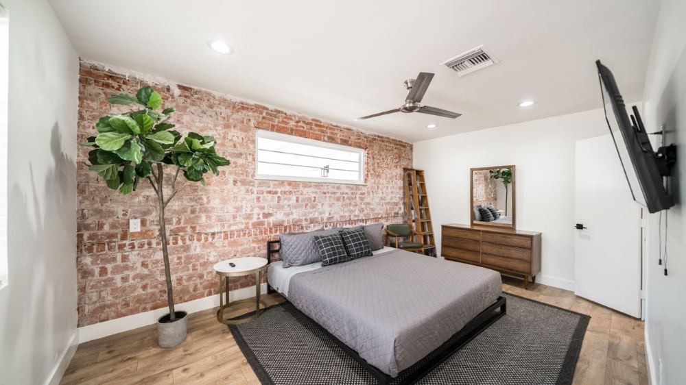 30 E Linda finished bedroom with exposed brick